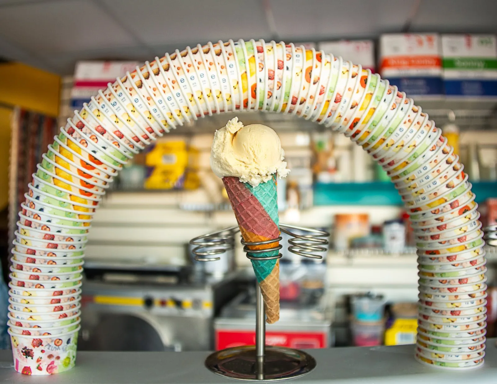 A playful arch of colourful paper cups around a Manfredi ice cream cone