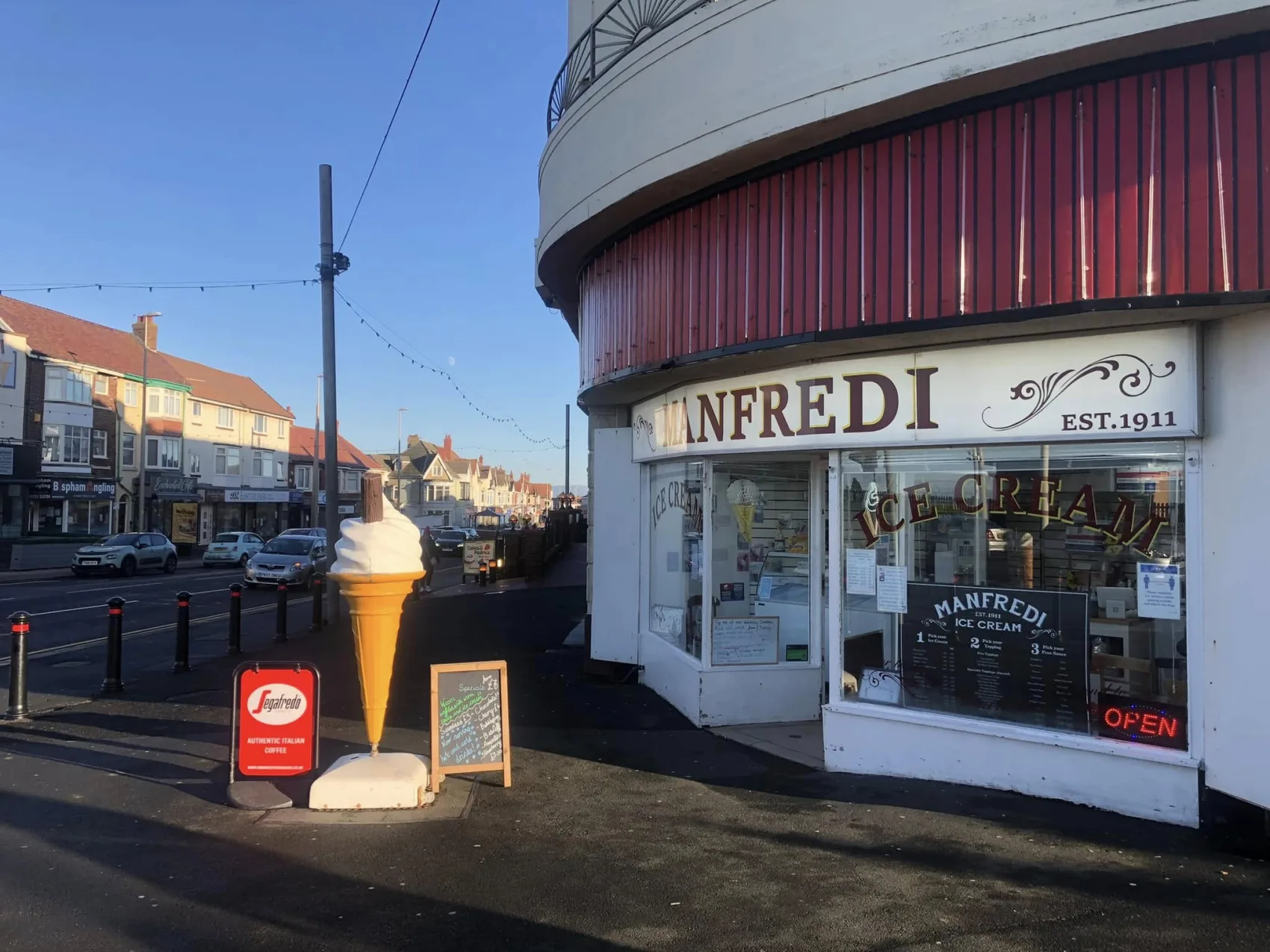 The Manfredi Ice Cream shopfront on Red Bank Road, Bispham, Blackpool, with a giant cone sign outside