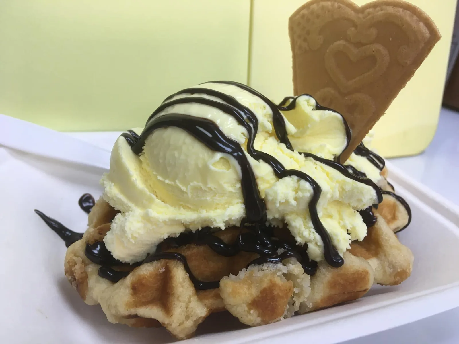 A warm Belgian waffle topped with Manfredi vanilla ice cream and chocolate sauce